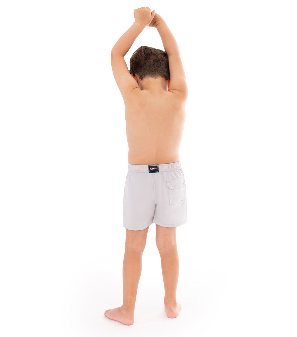 Gray Young boy wearing light gray shorts on a white background