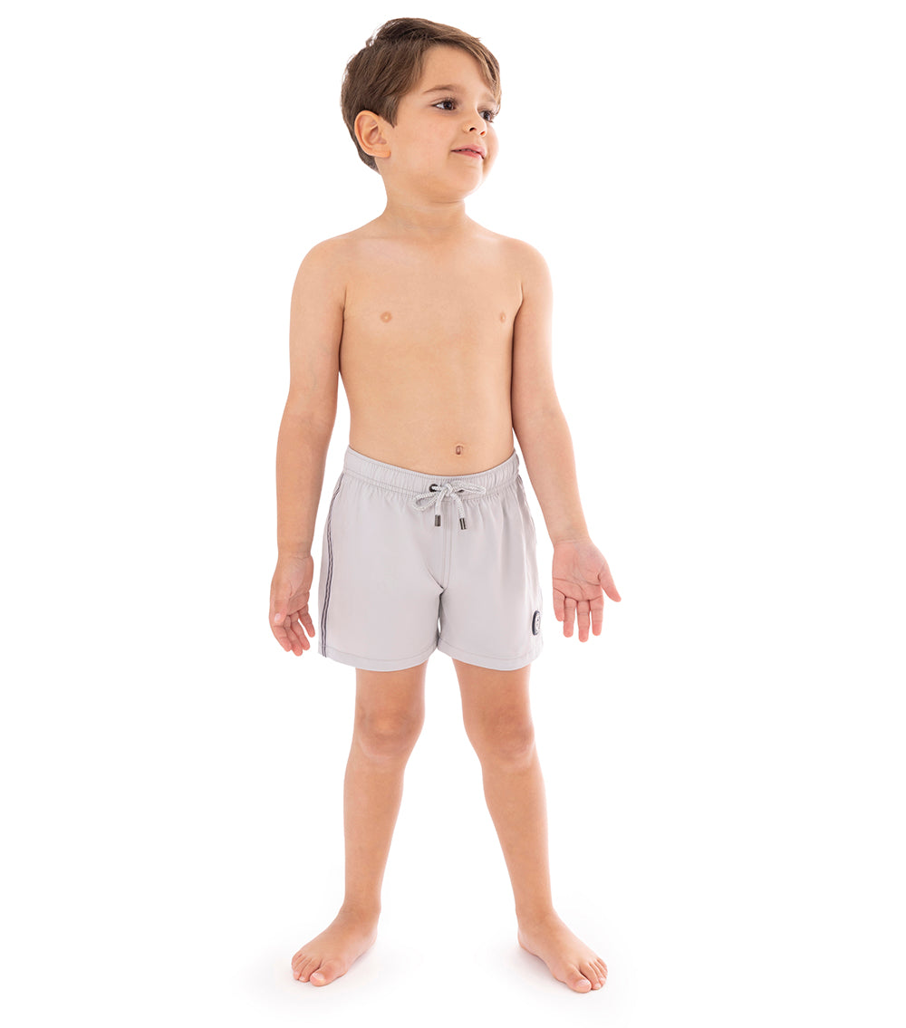 Gray Young boy wearing light gray shorts on a white background