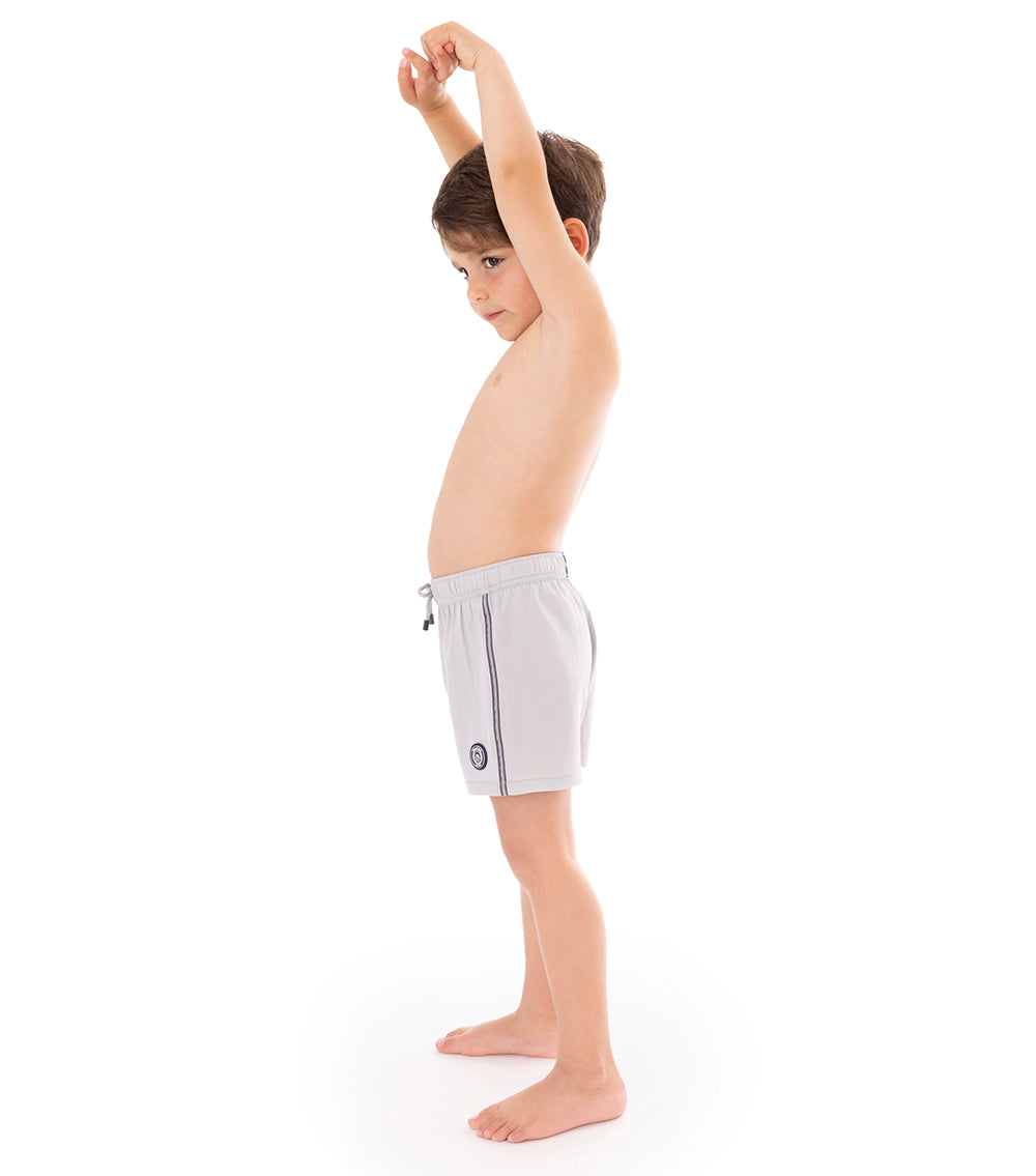 Gray Young boy wearing light gray shorts on a white background