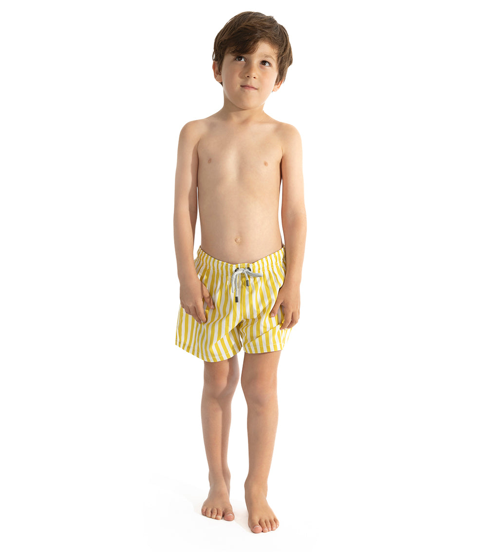 Yellow Stripes Young boy wearing yellow striped swim shorts on a white background
