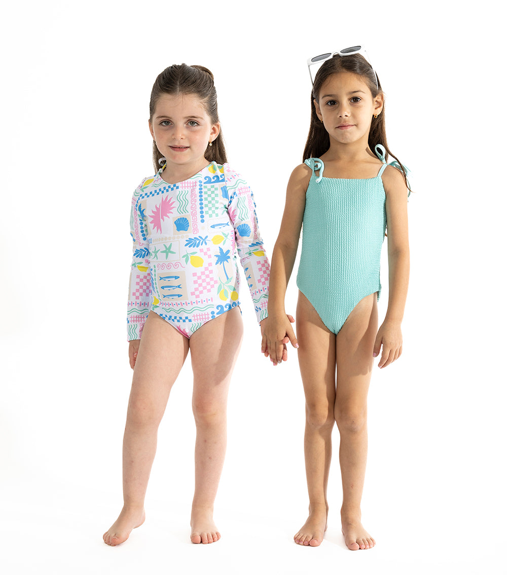 Aqua Two young girls wearing swimsuits on a white background