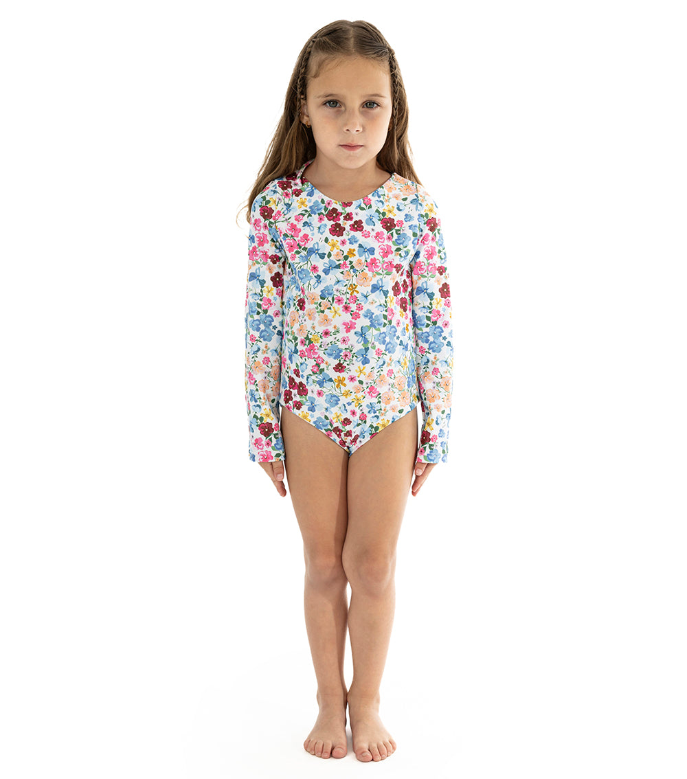 Flowers Young girl wearing a floral long-sleeve swimsuit on a white background