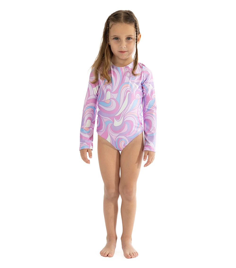Groovy Young girl wearing a purple and pink patterned swimsuit on a white background