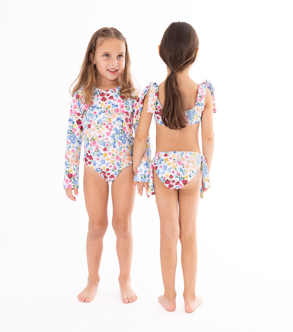 flowers Two children wearing a floral swimsuit on a white background