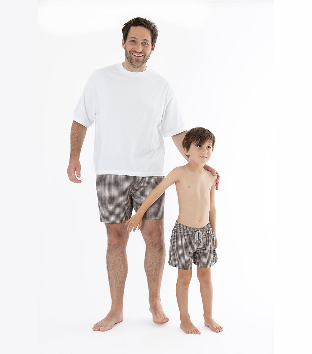 Houndstooth Father and Son wearing matching brown swimsuits