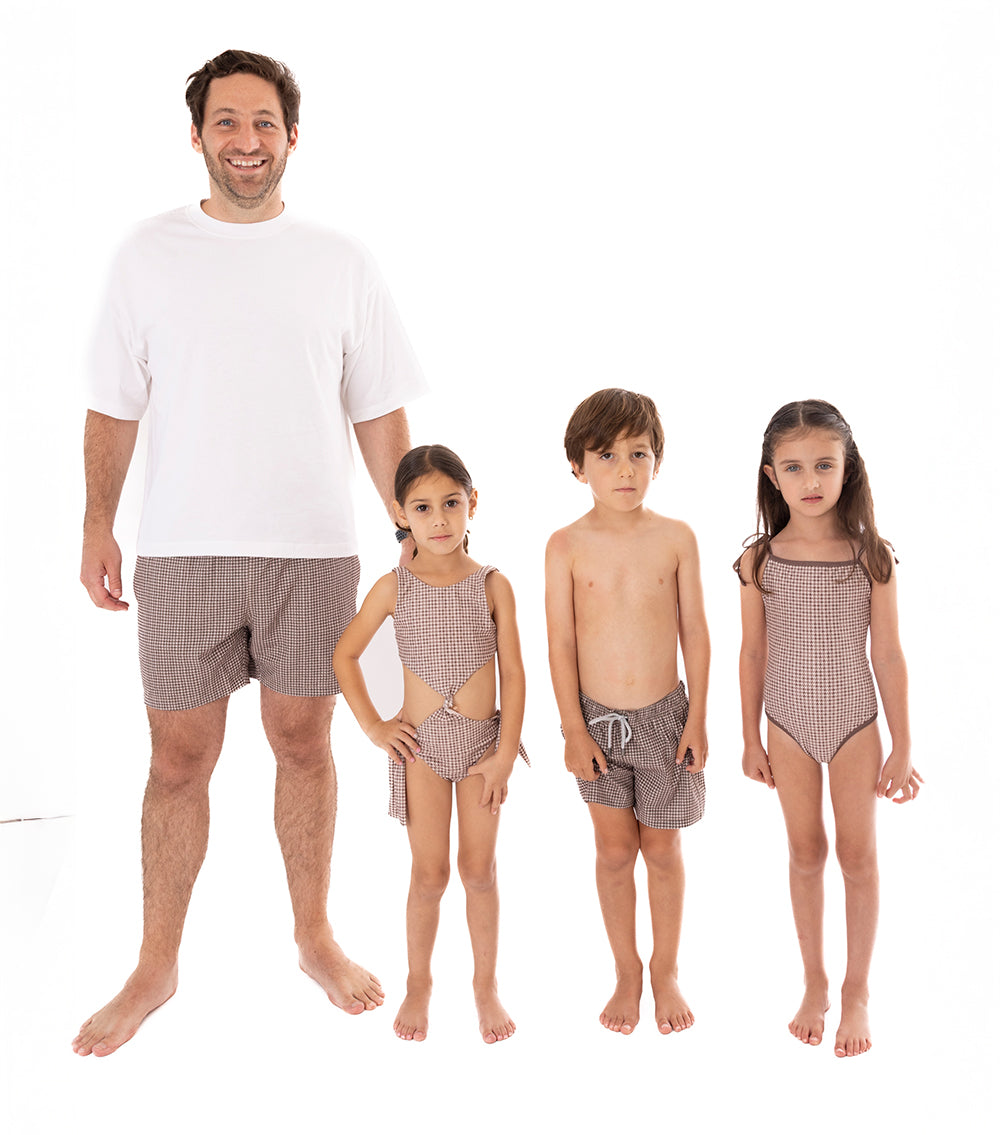 Houndstooth Father and two kids wearing matching swimsuits on a white background