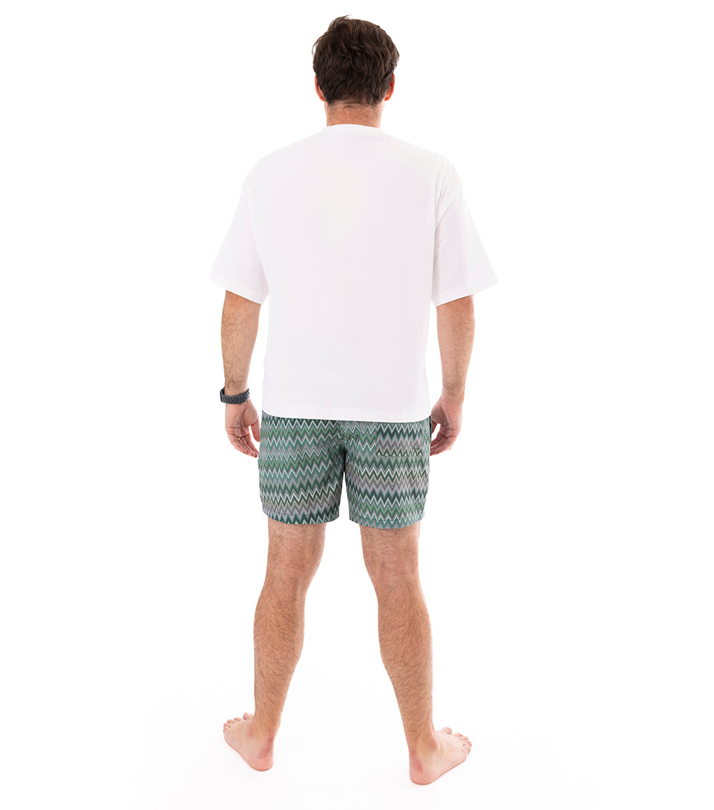 Chevron Man wearing green and white zigzag patterned shorts on a white background