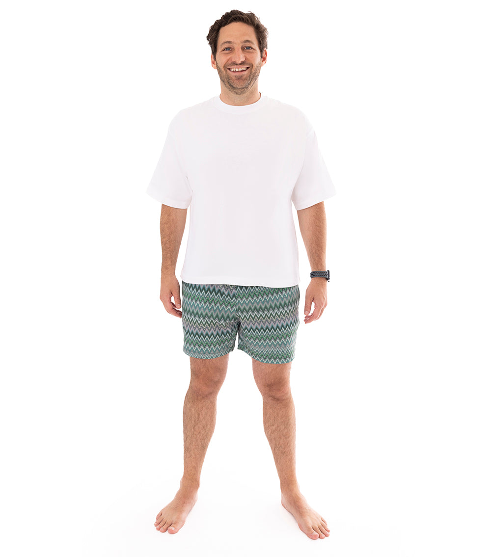 Chevron Man wearing green and white zigzag patterned shorts on a white background