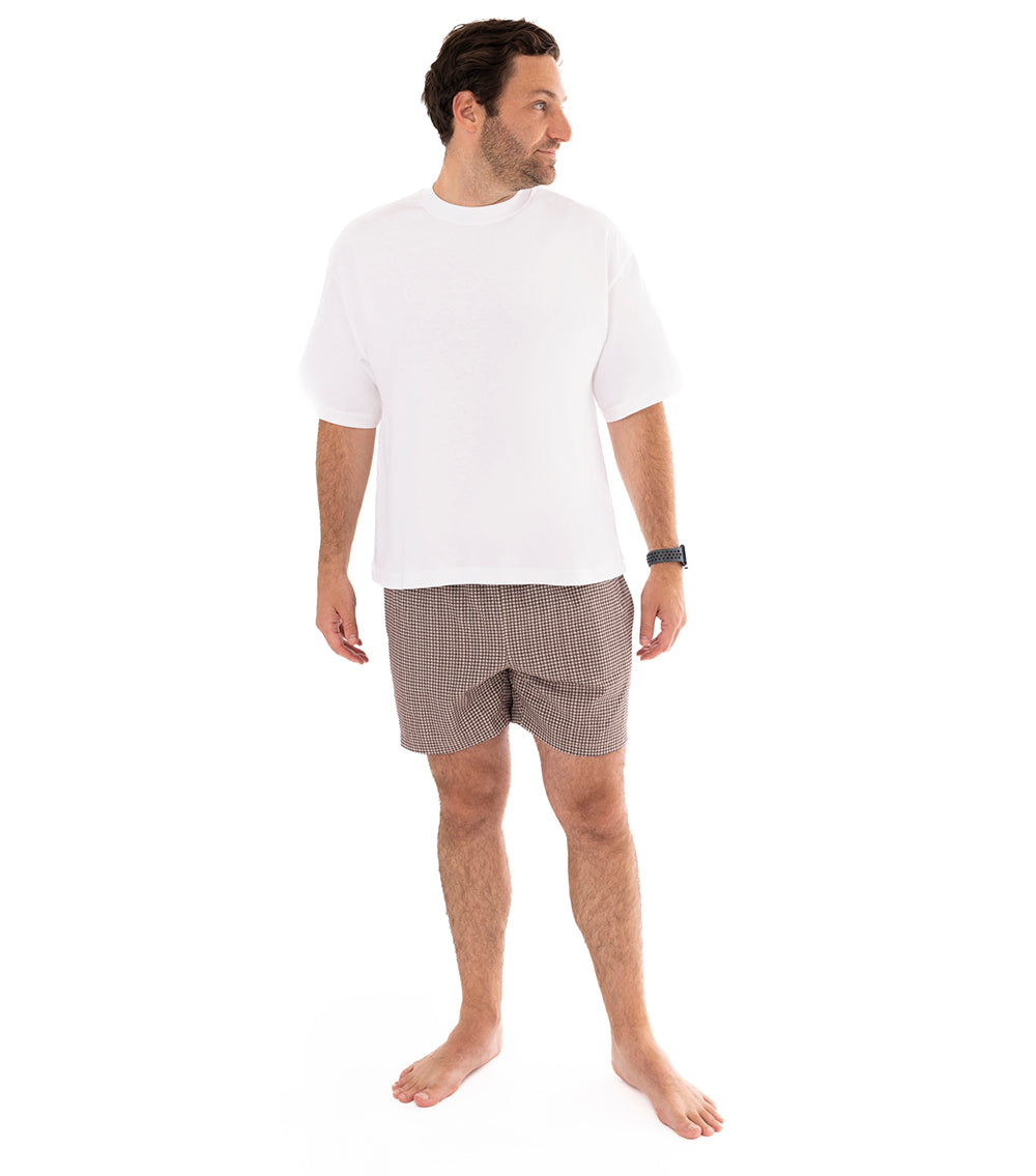Houndstooth Man wearing brown printed swim shorts