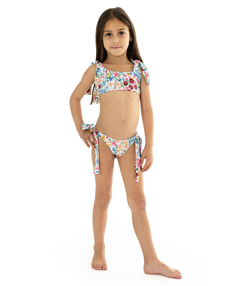 Flowers Young girl wearing a floral bikini set on a white background