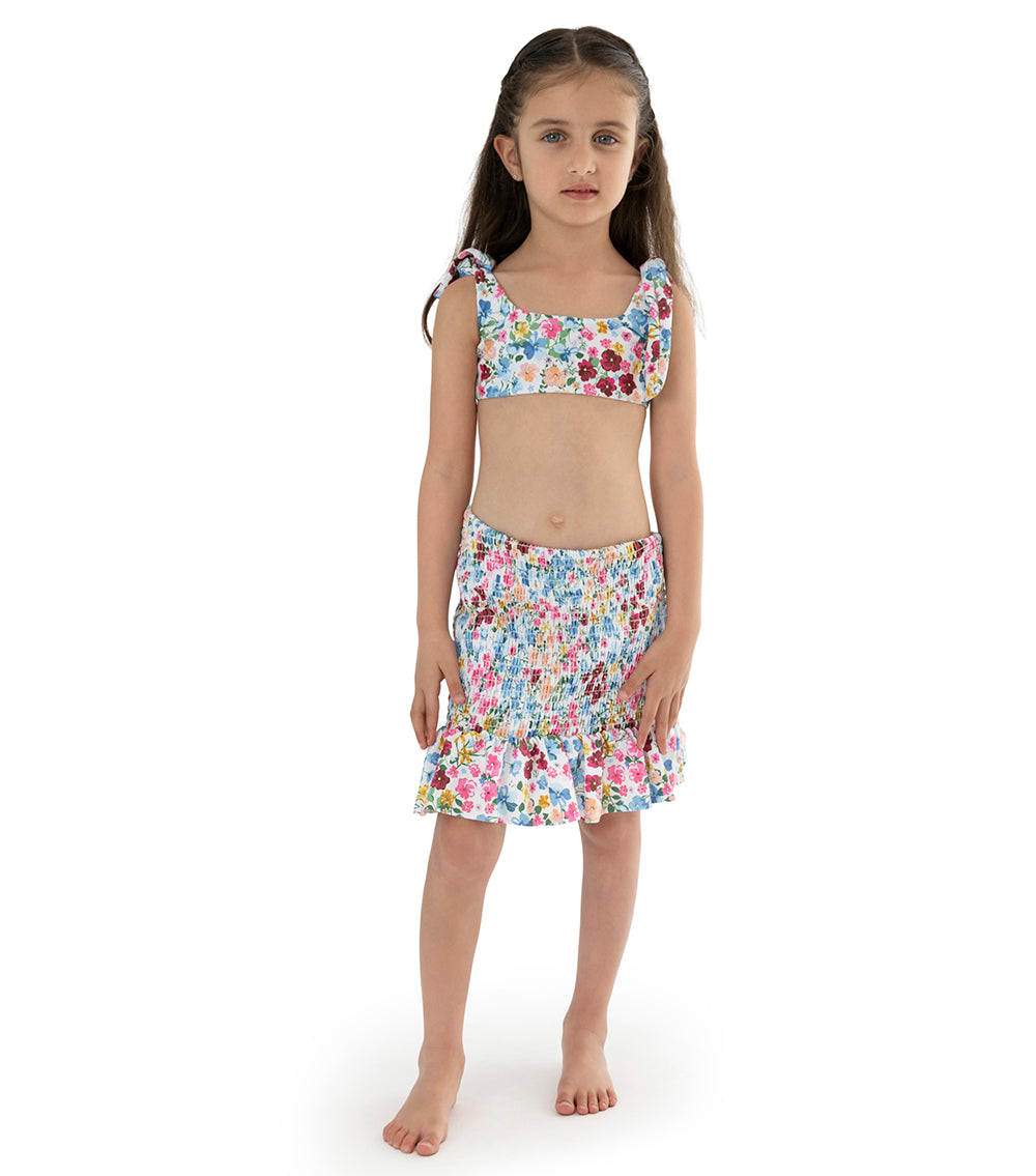 Flowers young girl wearing floral swimsuit with matching skirt