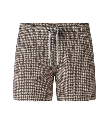 Houndstooth patterned shorts with a drawstring on a white background