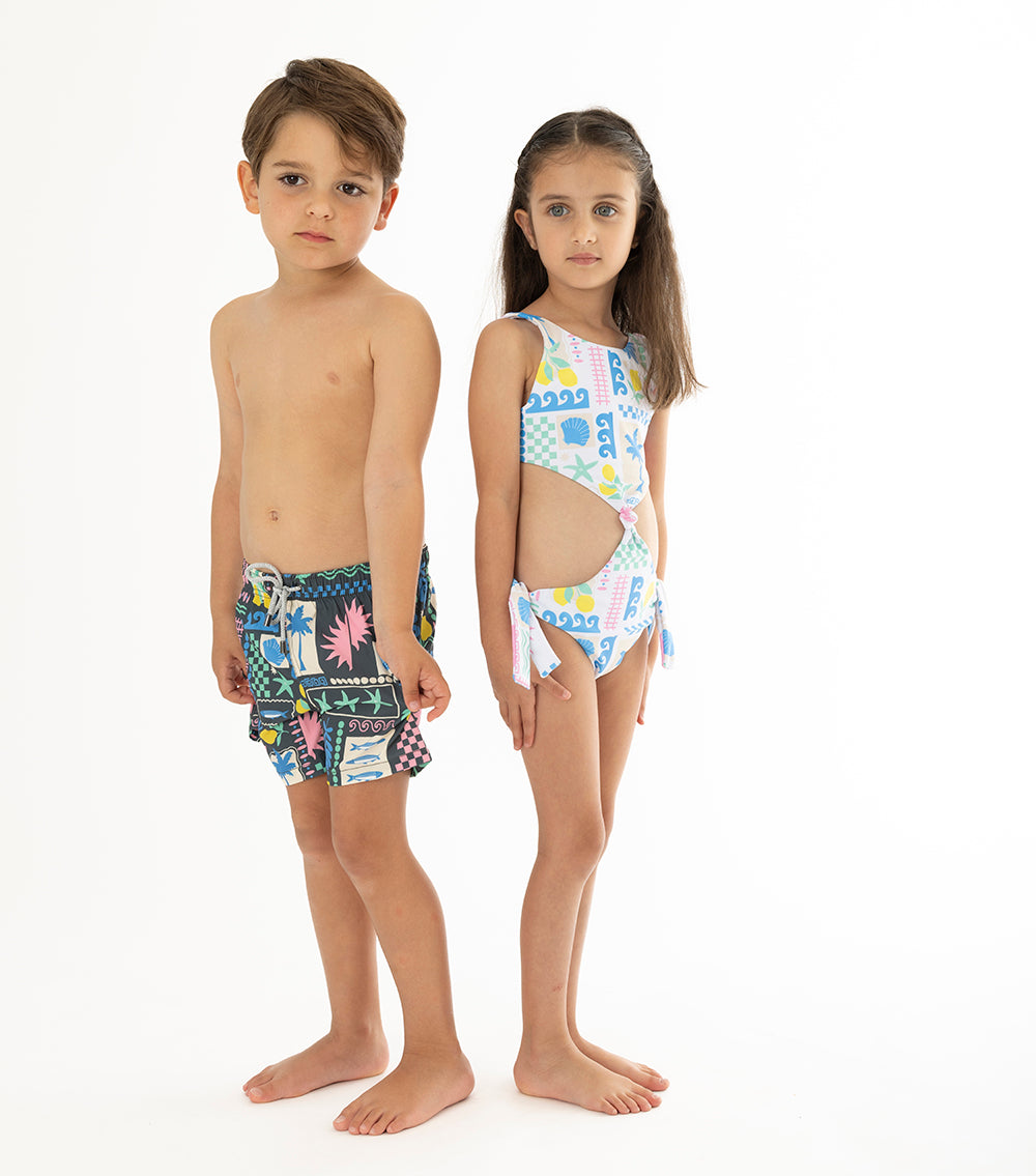 Capri White two children wearing colorful matching swimsuits