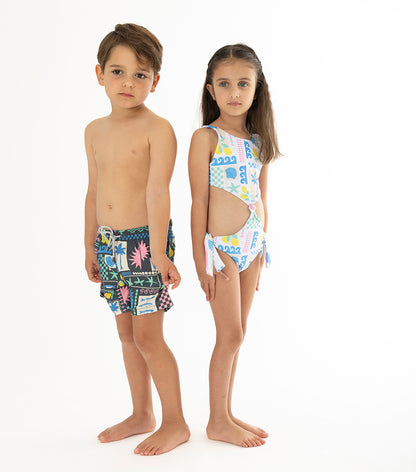 Capri White two children wearing colorful matching swimsuits