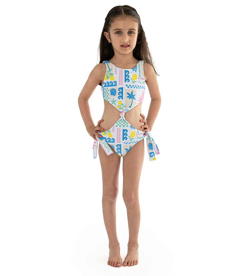 Capri White Young girl wearing a colorful swimsuit with a white background
