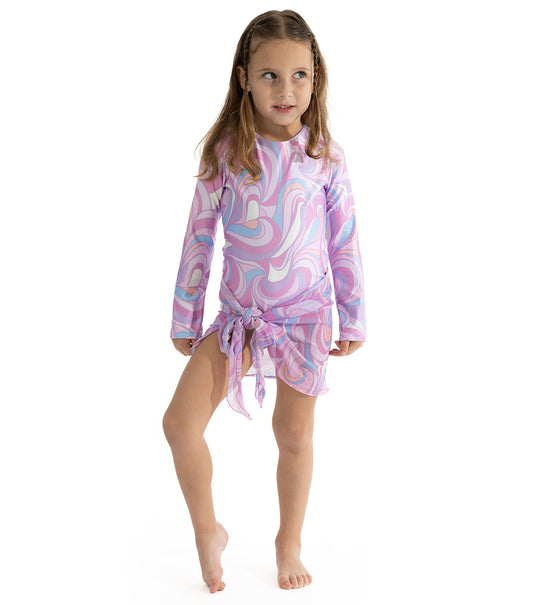 Groovy Girl wearing colorful pink and purple long sleeve swimsuit with matching mesh printed sarong