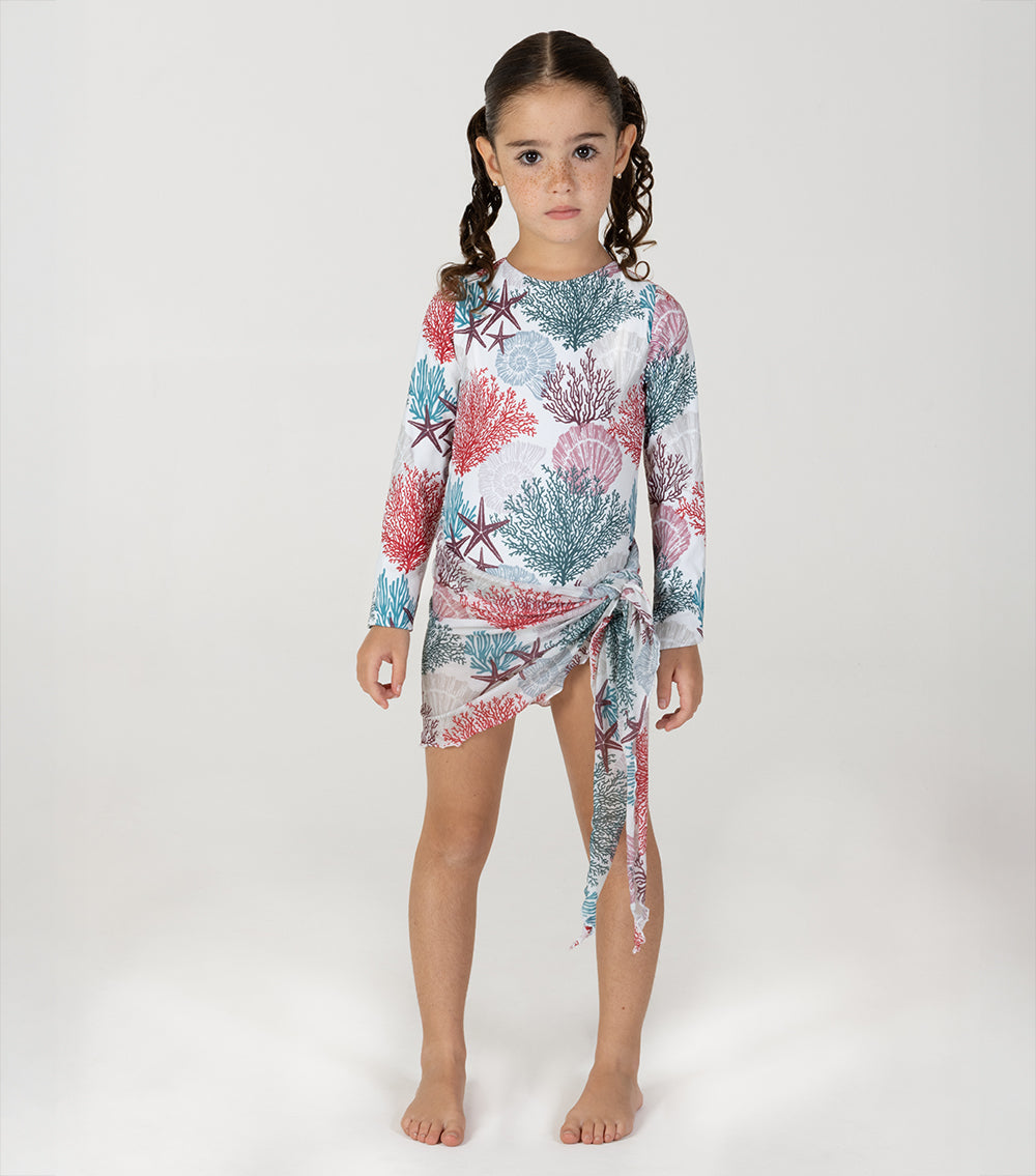 ivory corals Young girl wearing a long-sleeve shirt with a coral reef pattern on a white background