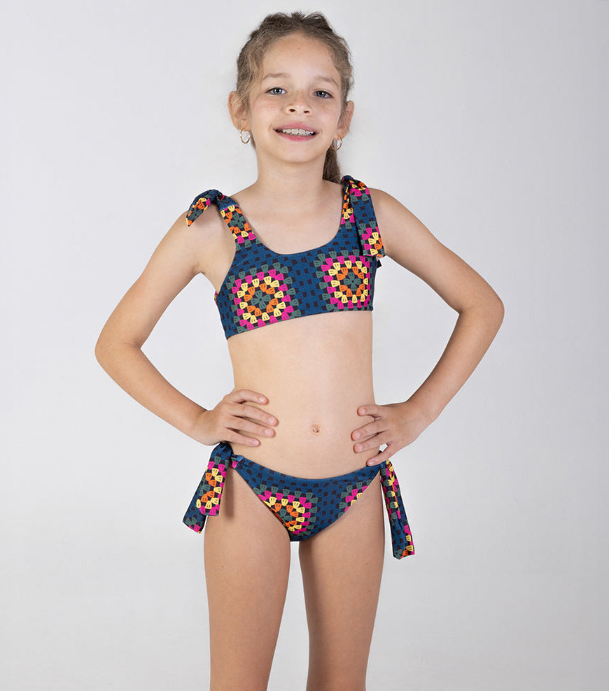 crochet Young girl wearing a colorful bikini set on a white background