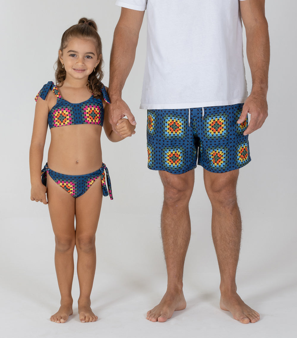 crochet Father and daughter wearing matching colorful swimwear on a white background