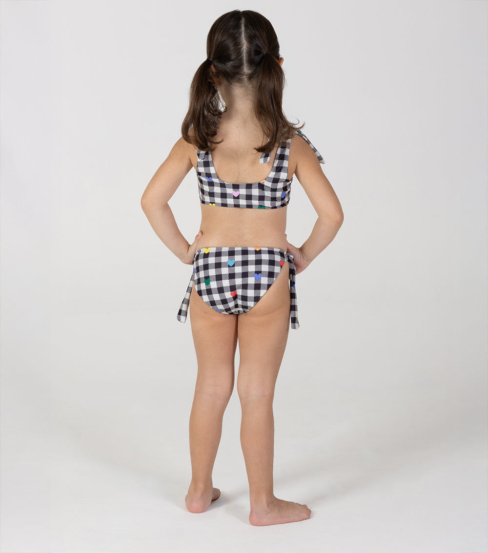 gingham emoji Child wearing a checkered bikini set on a white background