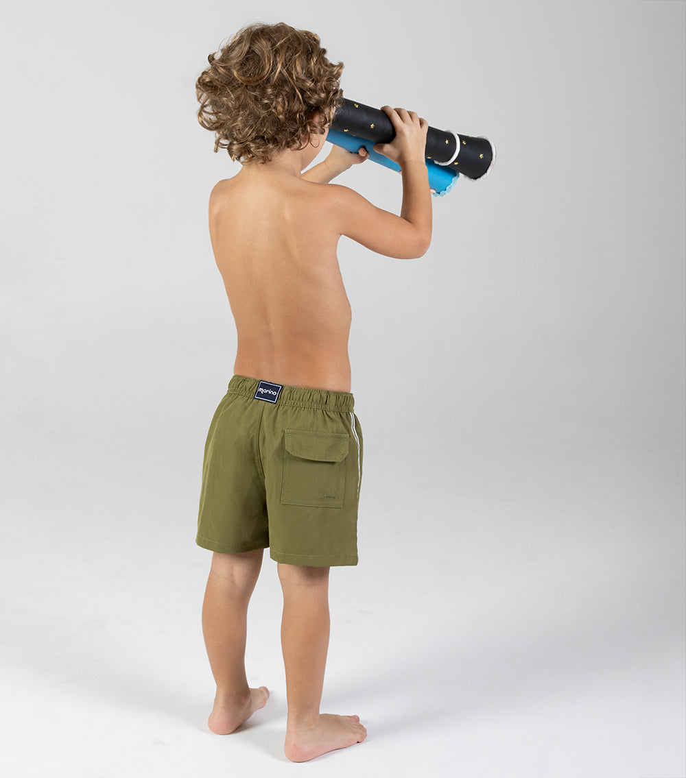 olive green Child wearing green shorts with a brand logo, holding a toy telescope against a white background