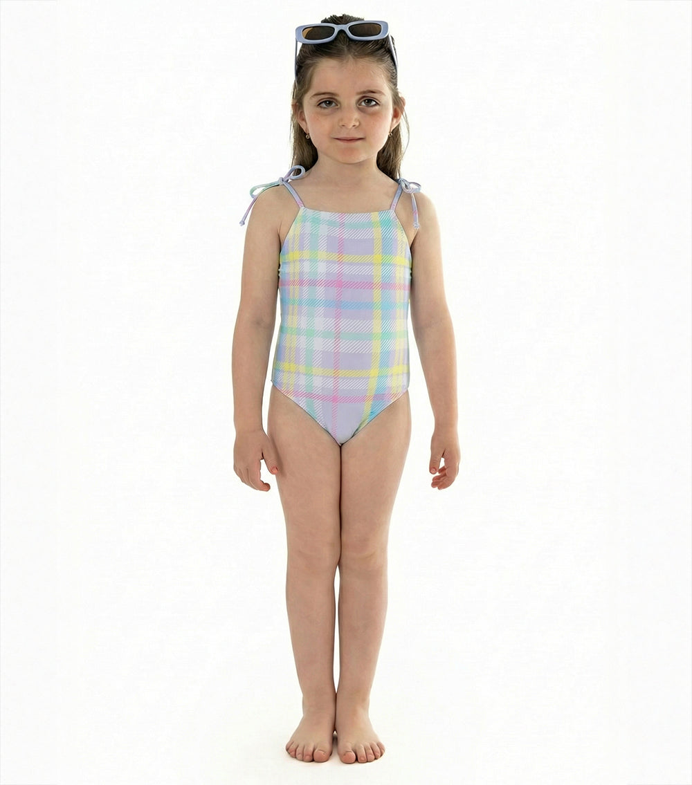 purple plaid Young girl wearing a pastel plaid swimsuit on a white background