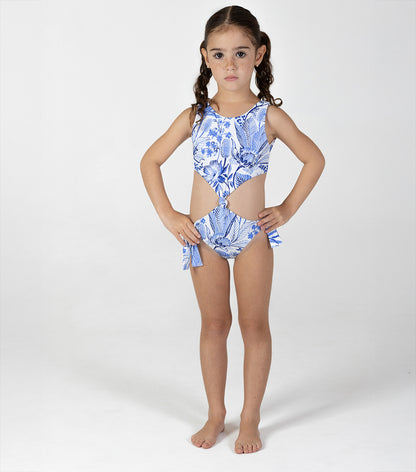 tropical Young girl wearing a blue floral swimsuit on a white background