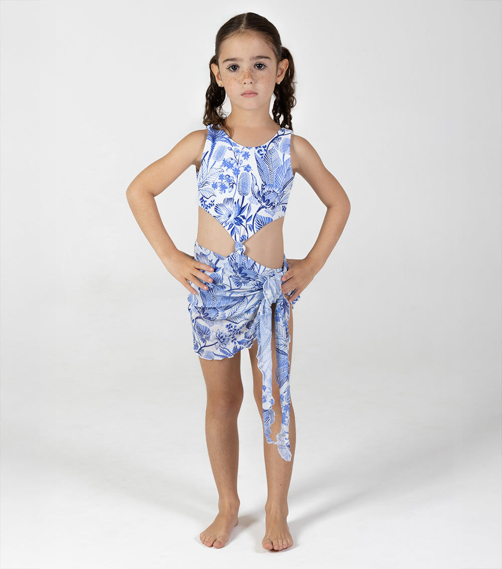 tropical Young girl wearing a blue floral swimsuit with a white background